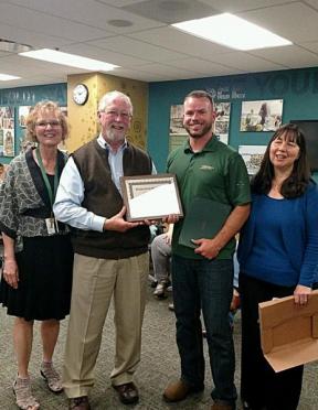 Mary Smith, Kevin O'Brien and Kim Coughlin-Lamphear presenting Travis with the SDRC Recognition Award